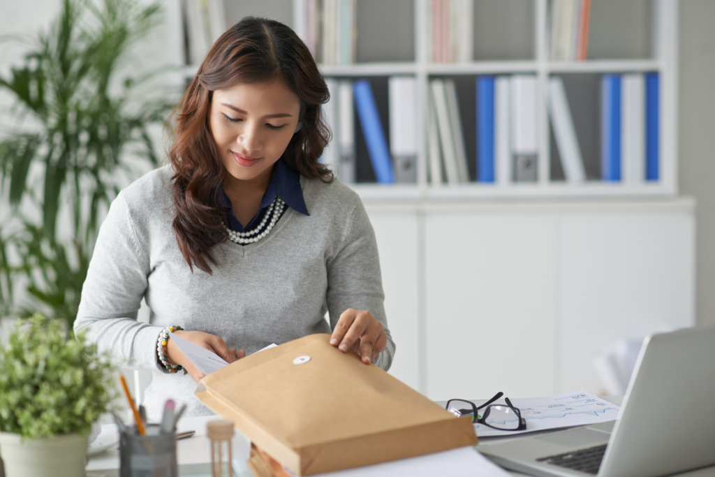 lady opening a hybrid mail envelope