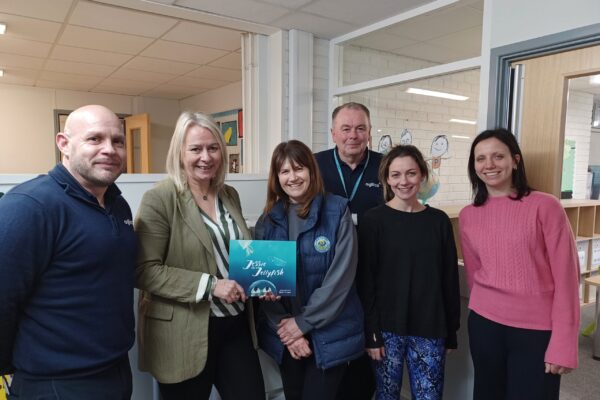 The leadership and support team at Lee on Solent Infant School receiving their new refurbished device and a copy of the Jessie the Jellyfish book.
